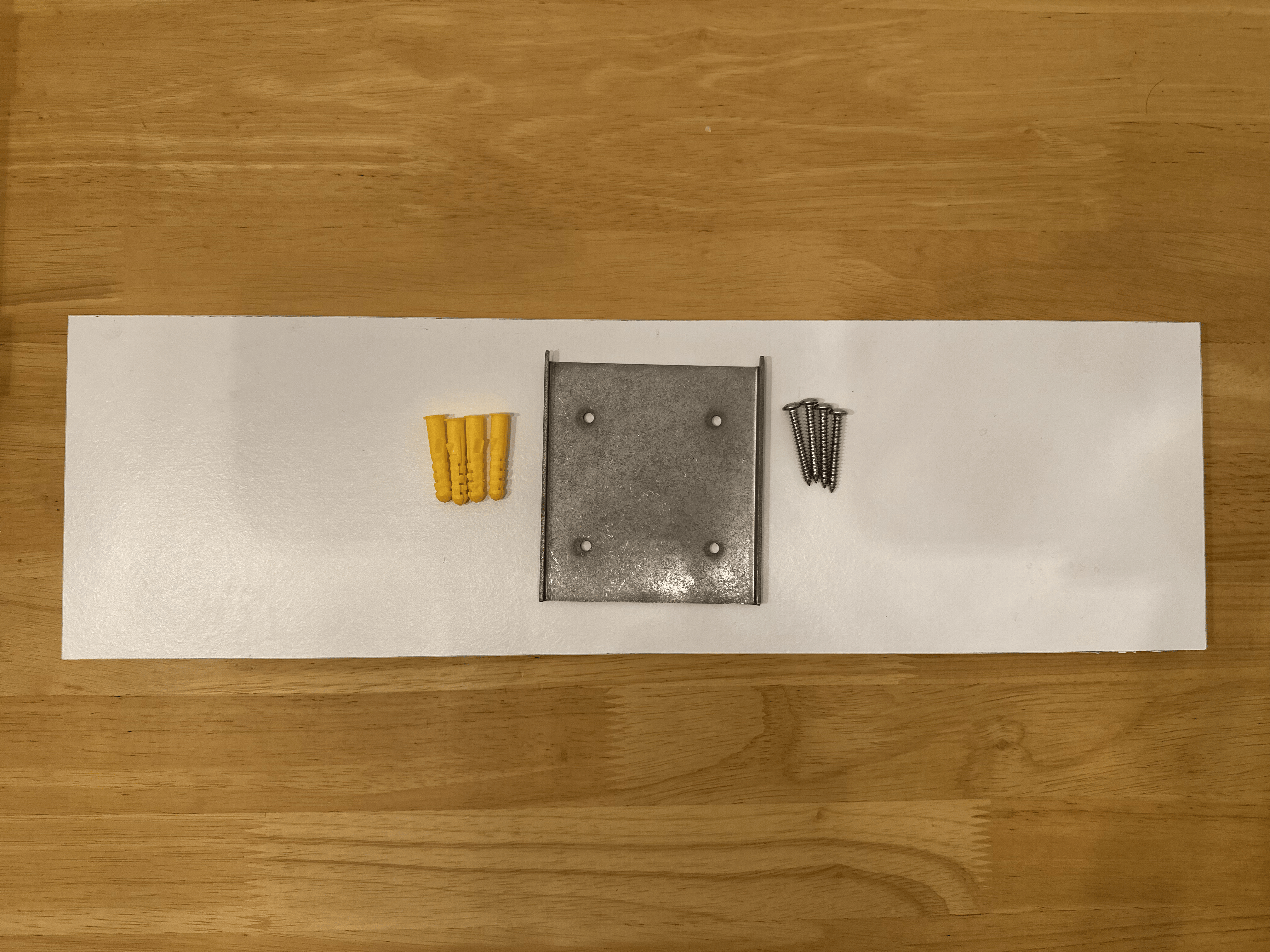 Included metal wall plate, wall plugs, and screws