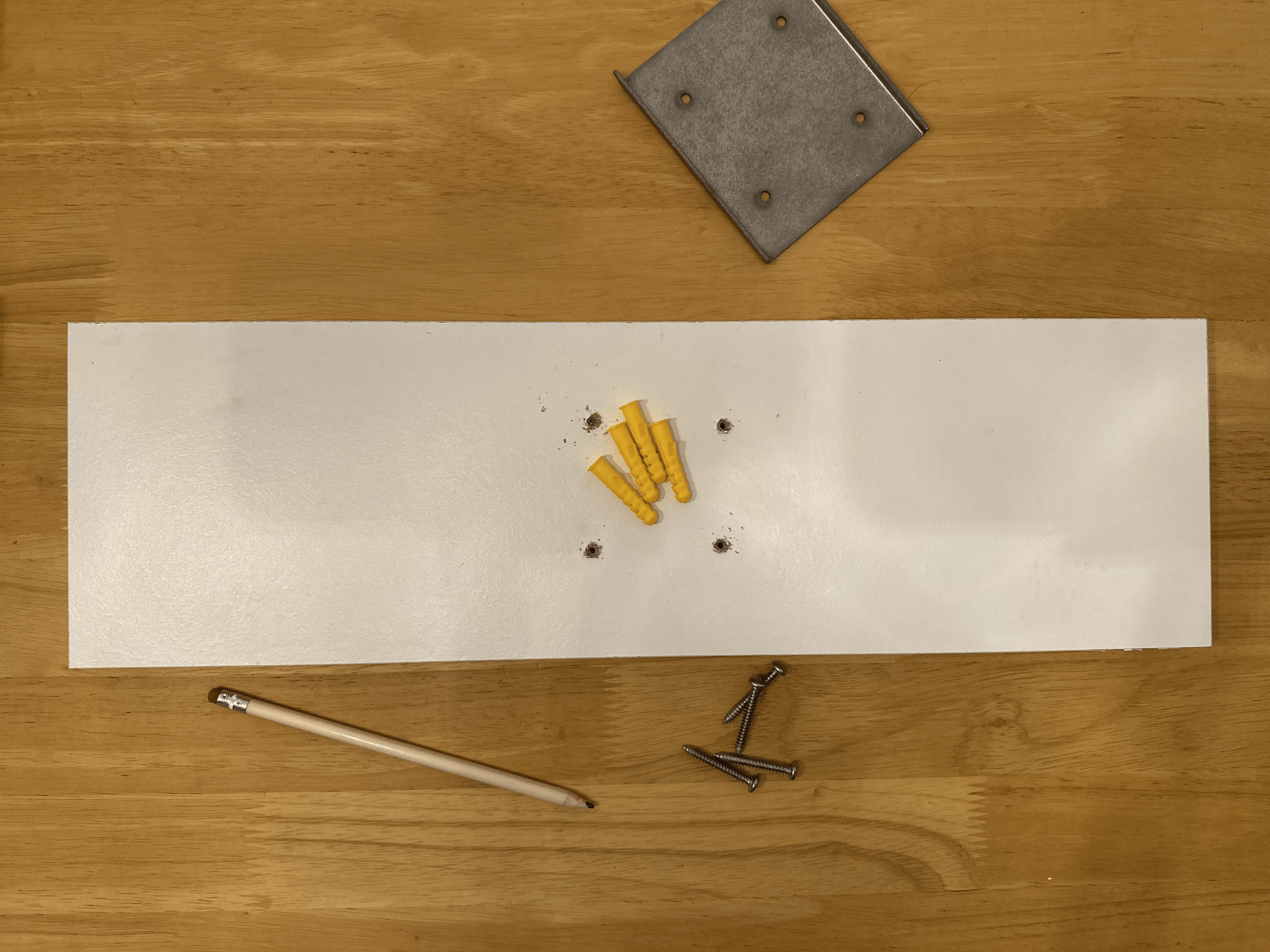 Drilled pilot holes and inserted wall plugs