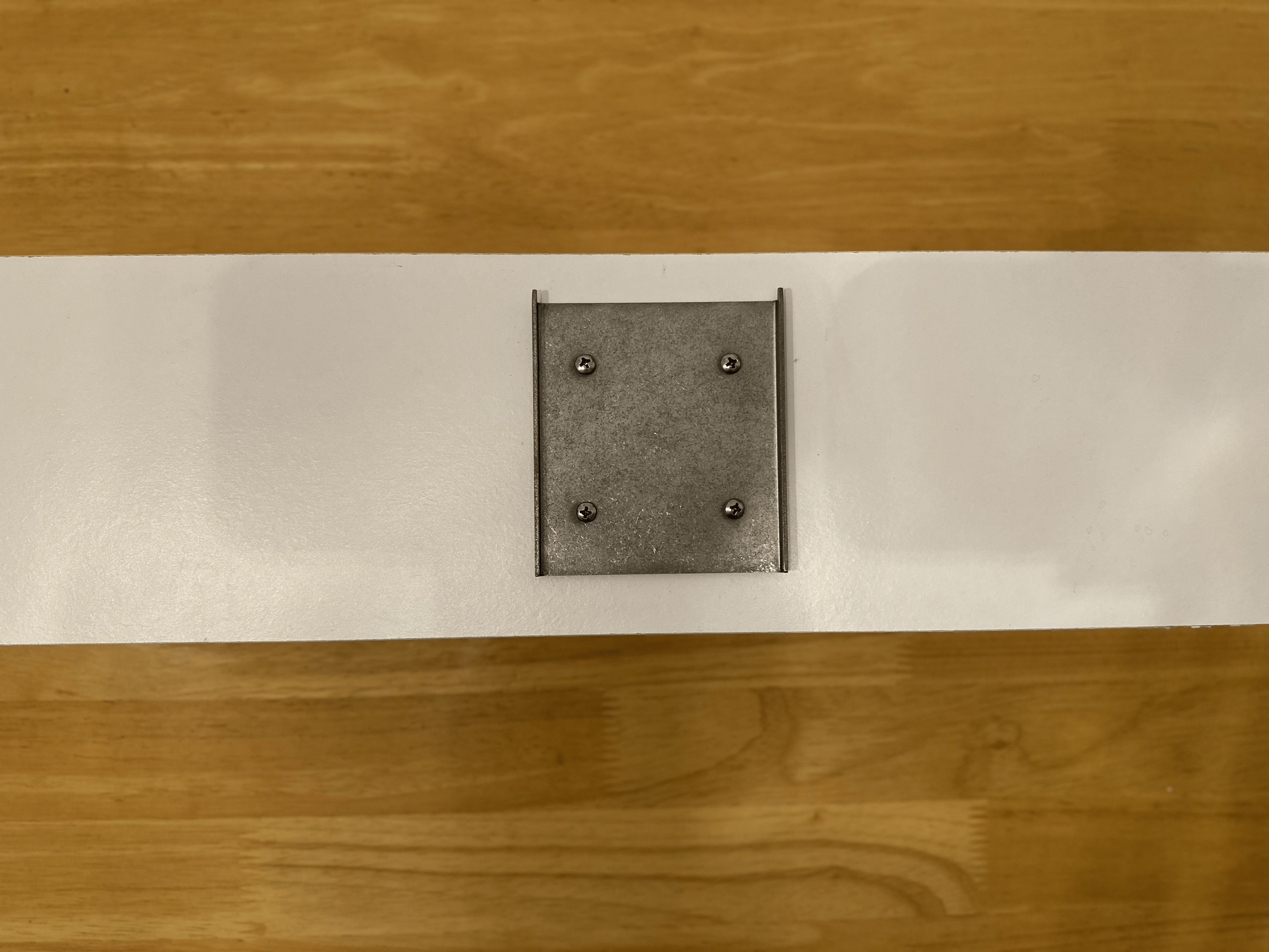 Metal mounting plate secured to the wall with screws